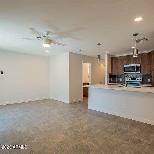 6227 North 13th Place, Unit 1 Phoenix, AZ 85014 - Photo 6 of 16 an empty room with kitchen and ceiling fan