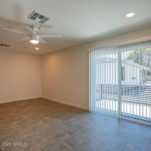 6227 North 13th Place, Unit 1 Phoenix, AZ 85014 - Photo 8 of 16 an empty room with a ceiling fan and window