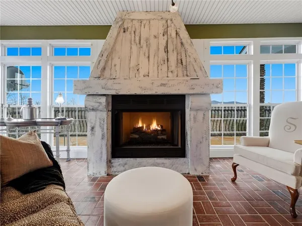 a room with lots of furniture and a potted plant