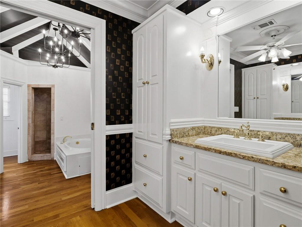 988 Hunters Ridge Jasper, GA 30143 - Photo 38 of 87 a spacious bathroom with a granite countertop sink a mirror and shower