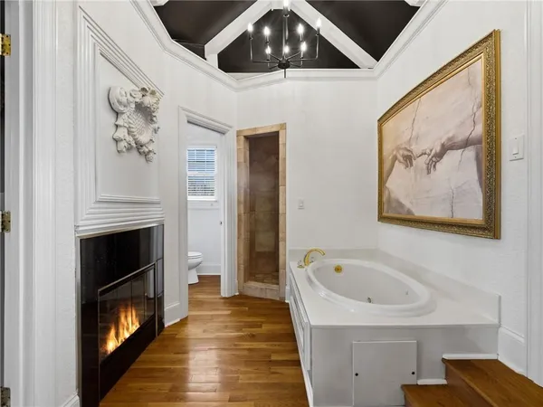 a bathroom with a sink mirror toilet and shower