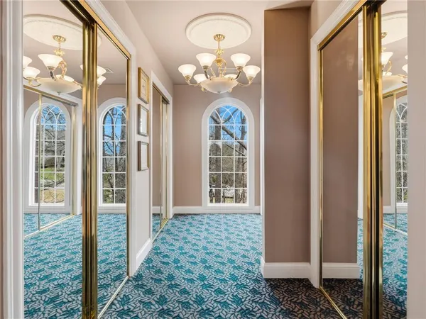 a living room with furniture a dining table and a large window
