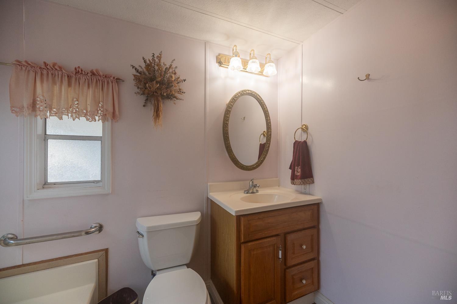 316 Círculo Durango Rohnert Park, CA 94928 - Photo 23 of 33 a bathroom with a toilet sink vanity and mirror
