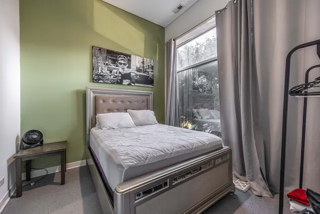 a bedroom with a bed and a window