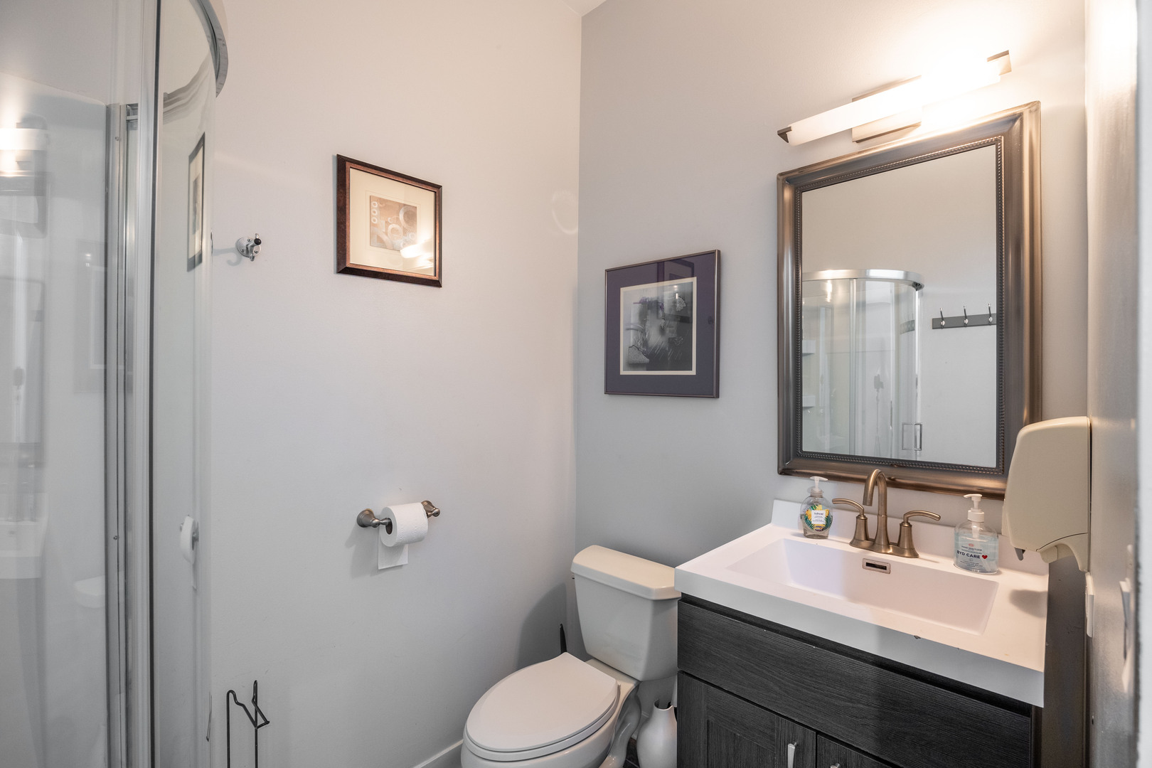 1002 West Lake Street, Unit 2 Chicago, IL 60607 - Photo 15 of 29 a bathroom with a toilet a sink and mirror