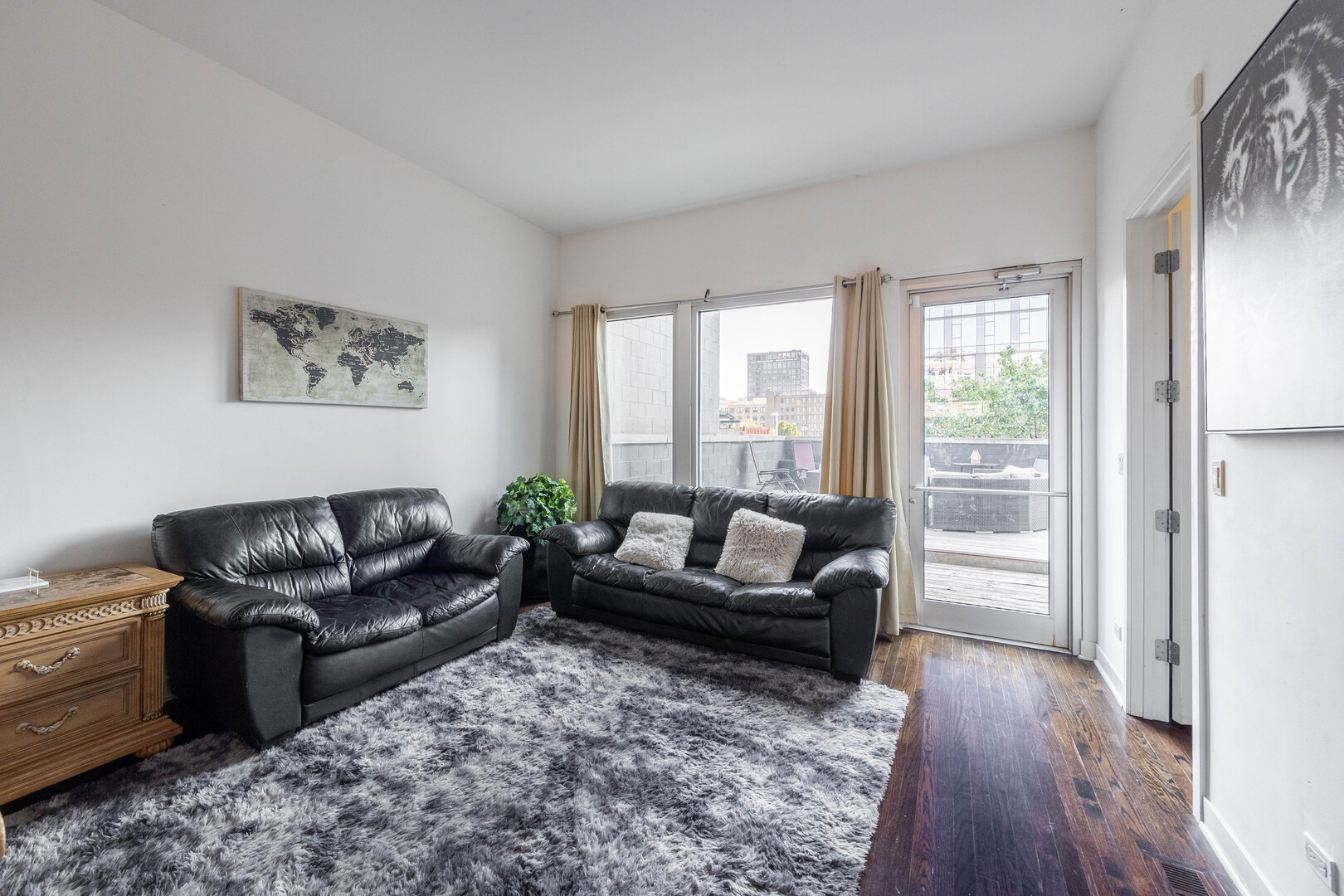 1002 West Lake Street, Unit 2 Chicago, IL 60607 - Photo 17 of 29 a living room with furniture and a large window