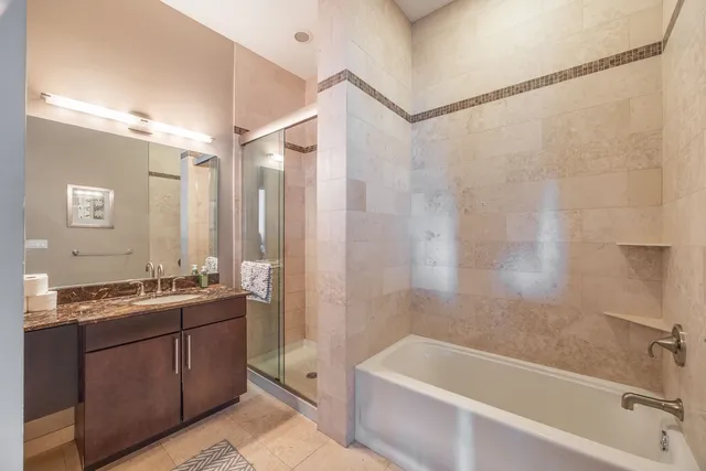 a bathroom with a tub sink and mirror