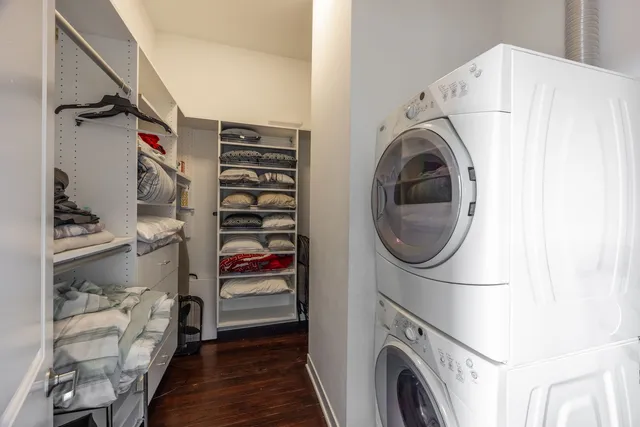 a view of walk in closet with clothes and shoes