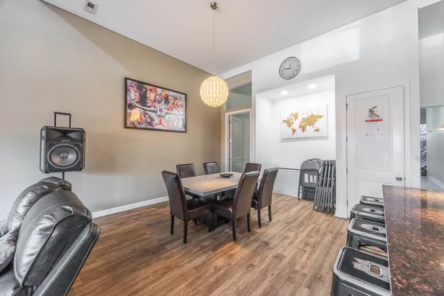 a view of a dining room with furniture and wooden floor