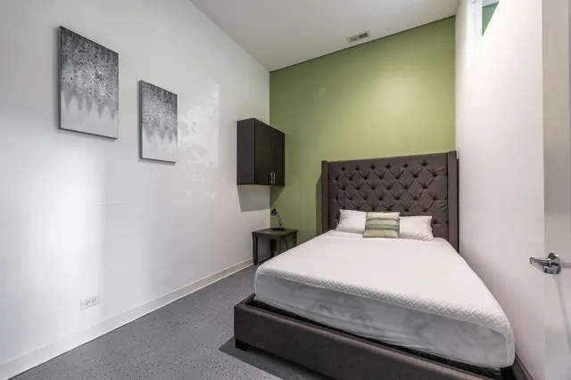 a bedroom with a bed and a flat screen tv