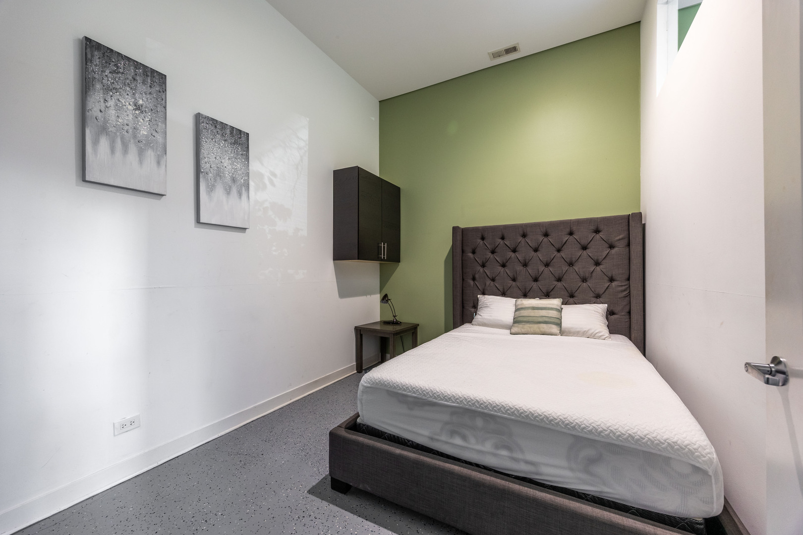 1002 West Lake Street, Unit 2 Chicago, IL 60607 - Photo 21 of 29 a bedroom with a bed and a flat screen tv