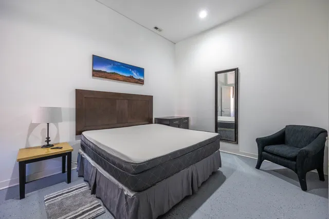 a bedroom with a bed and a desk