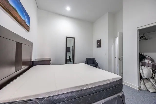 a large white bed in a white room