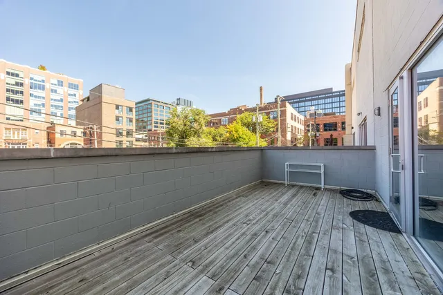a view of roof deck with wooden floor and fence