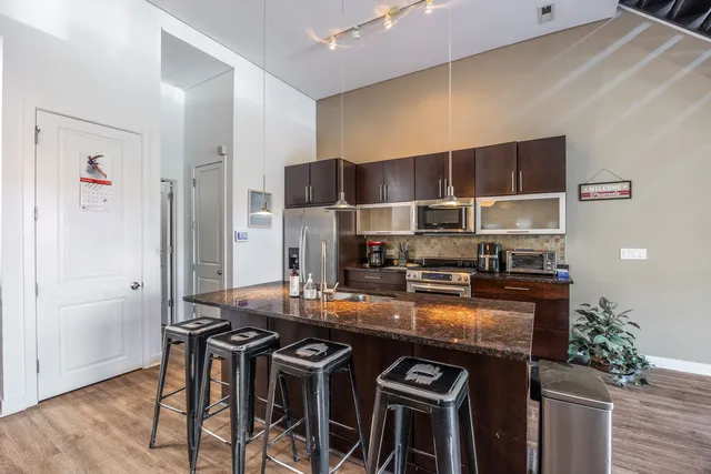 a kitchen with stainless steel appliances granite countertop a stove and a refrigerator