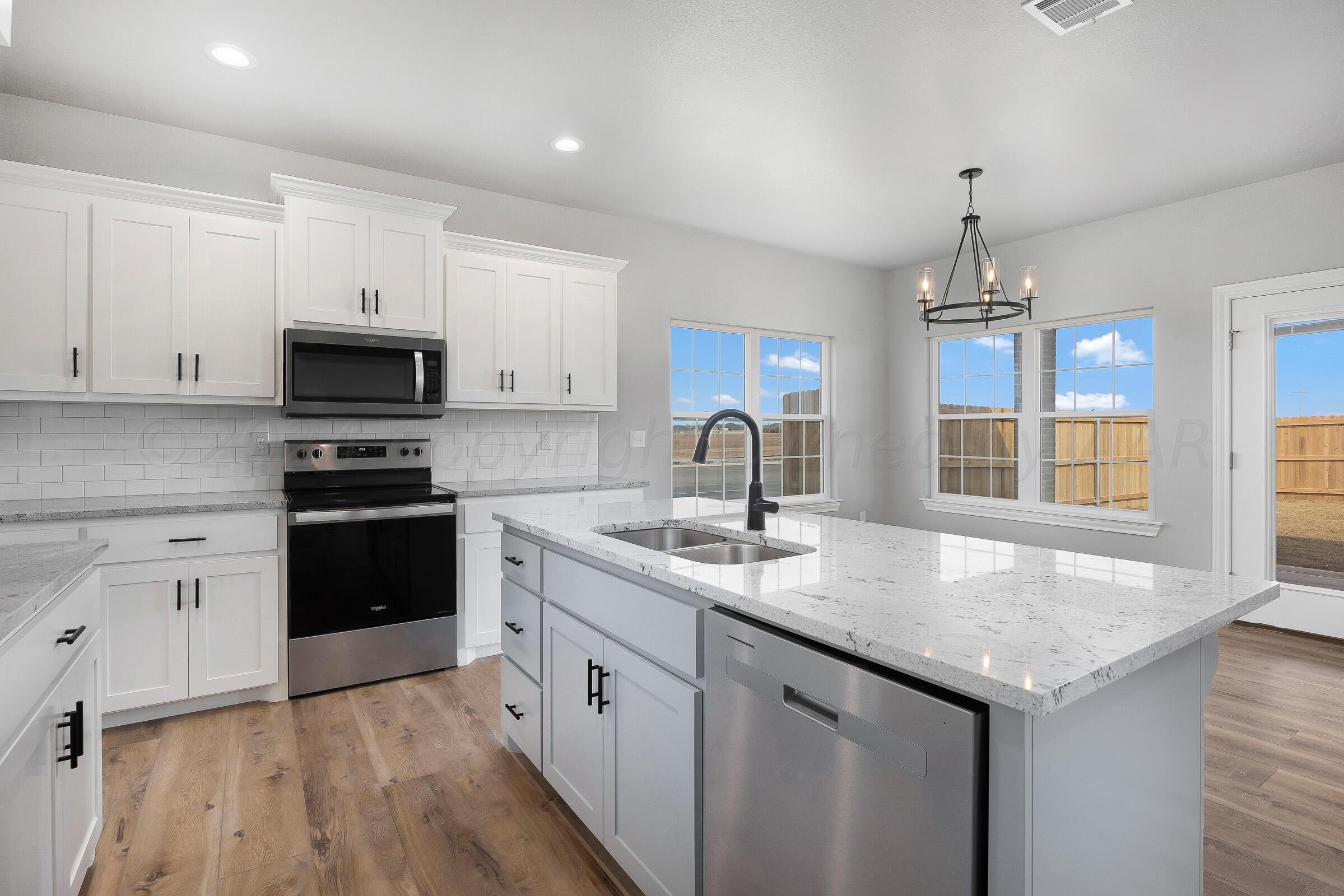 7501 John Thomas Street Amarillo, TX 79119 - Photo 12 of 30 a kitchen with a sink stove top oven and microwave