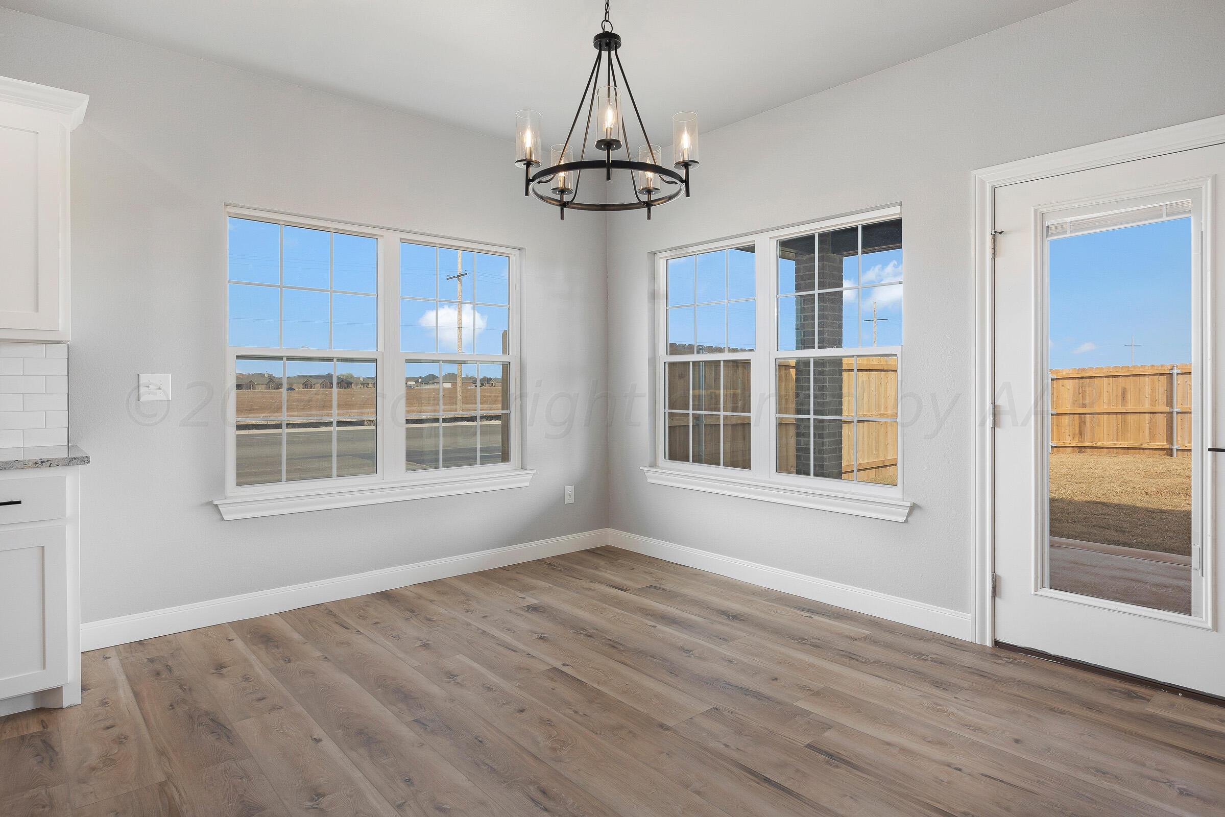 7501 John Thomas Street Amarillo, TX 79119 - Photo 13 of 30 a view of an empty room with wooden floor and a window