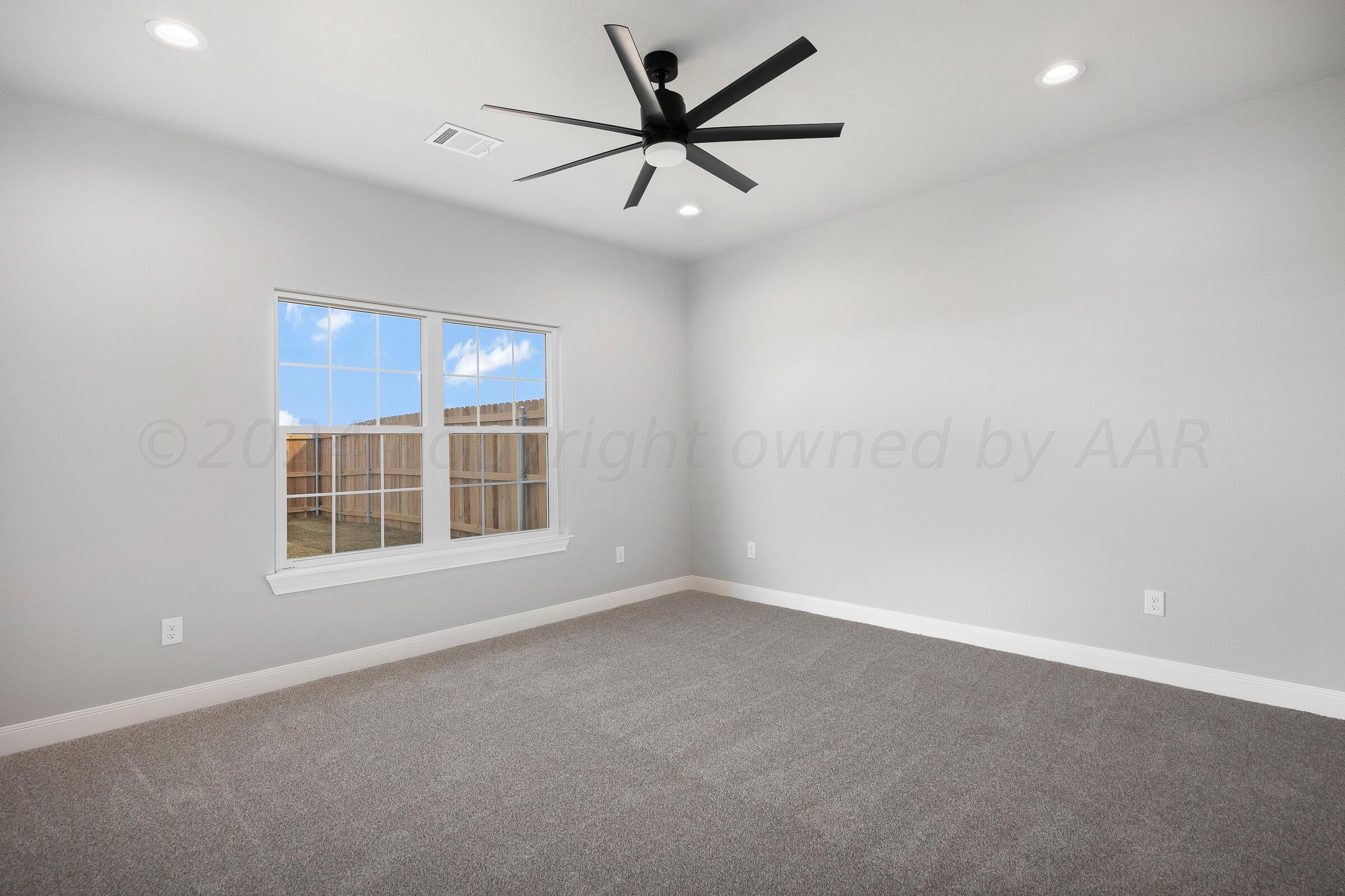 7501 John Thomas Street Amarillo, TX 79119 - Photo 15 of 30 an empty room with windows and fan