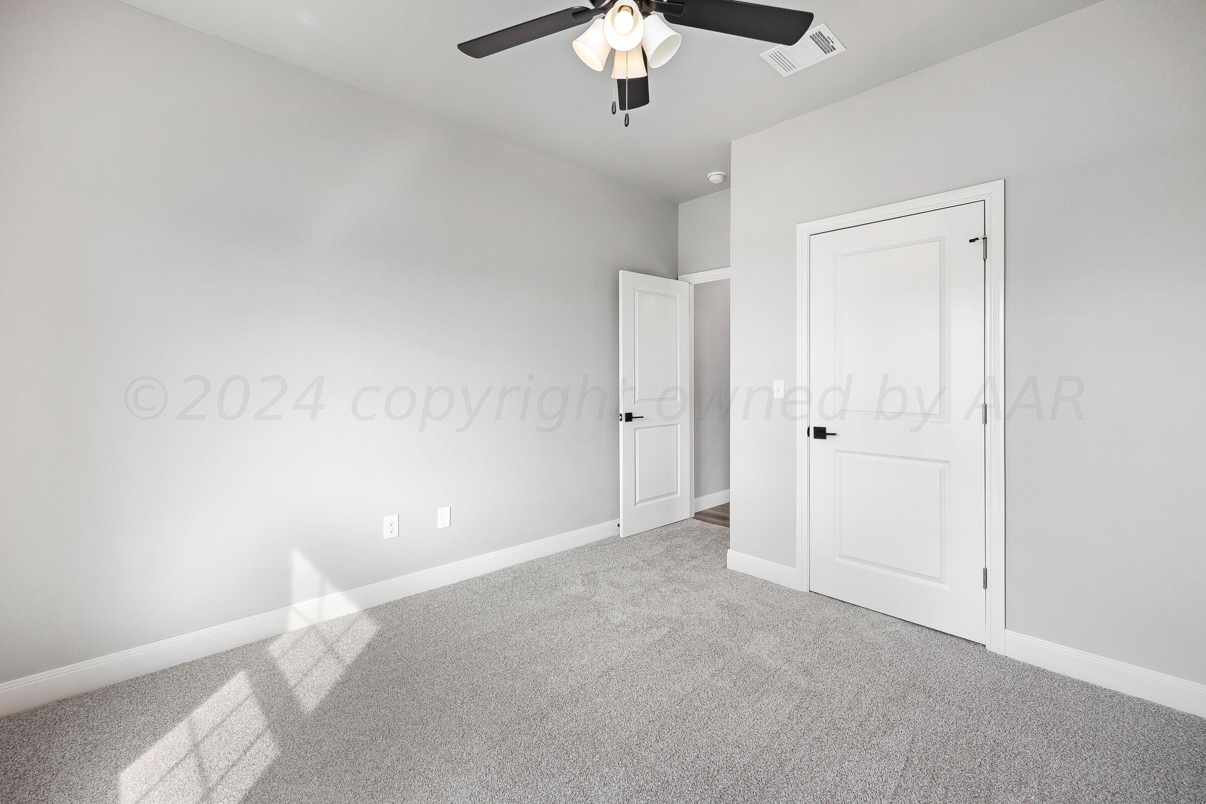 7501 John Thomas Street Amarillo, TX 79119 - Photo 26 of 30 a view of an empty room with a chandelier fan