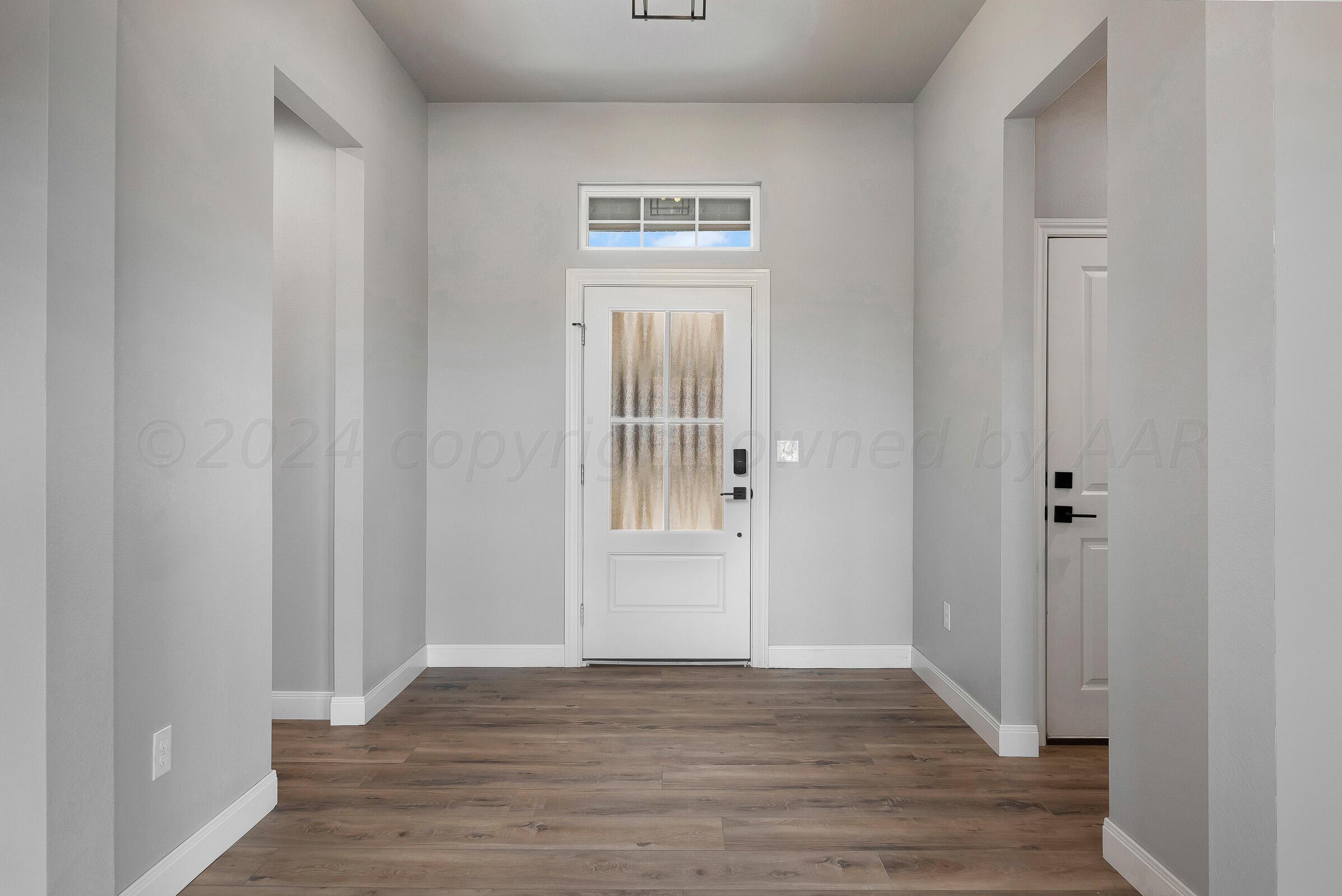 7501 John Thomas Street Amarillo, TX 79119 - Photo 4 of 30 a view of an empty room with wooden floor