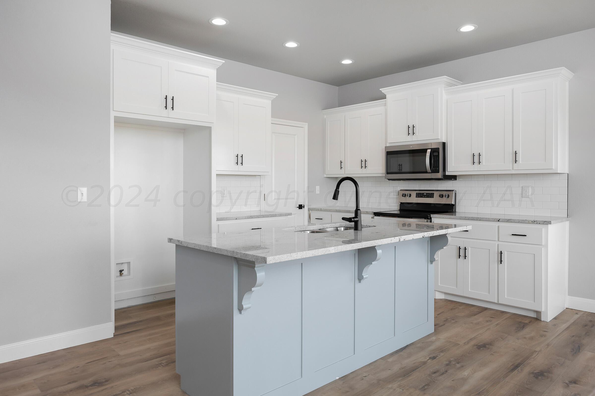 7501 John Thomas Street Amarillo, TX 79119 - Photo 8 of 30 a kitchen with appliances cabinets and a sink