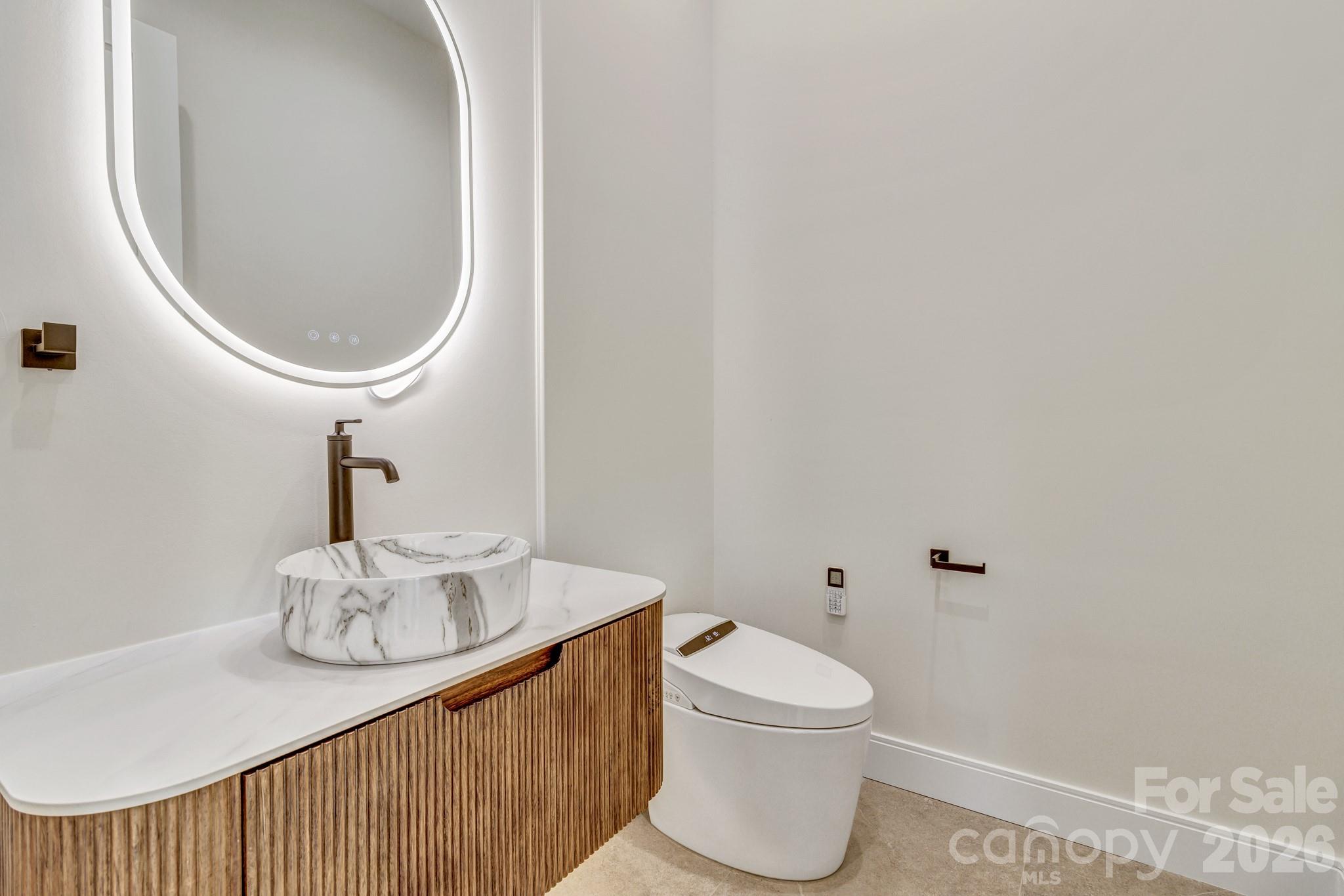 134 View Ridge Parkway Leicester, NC 28748 - Photo 17 of 48 a bathroom with a toilet a sink and mirror