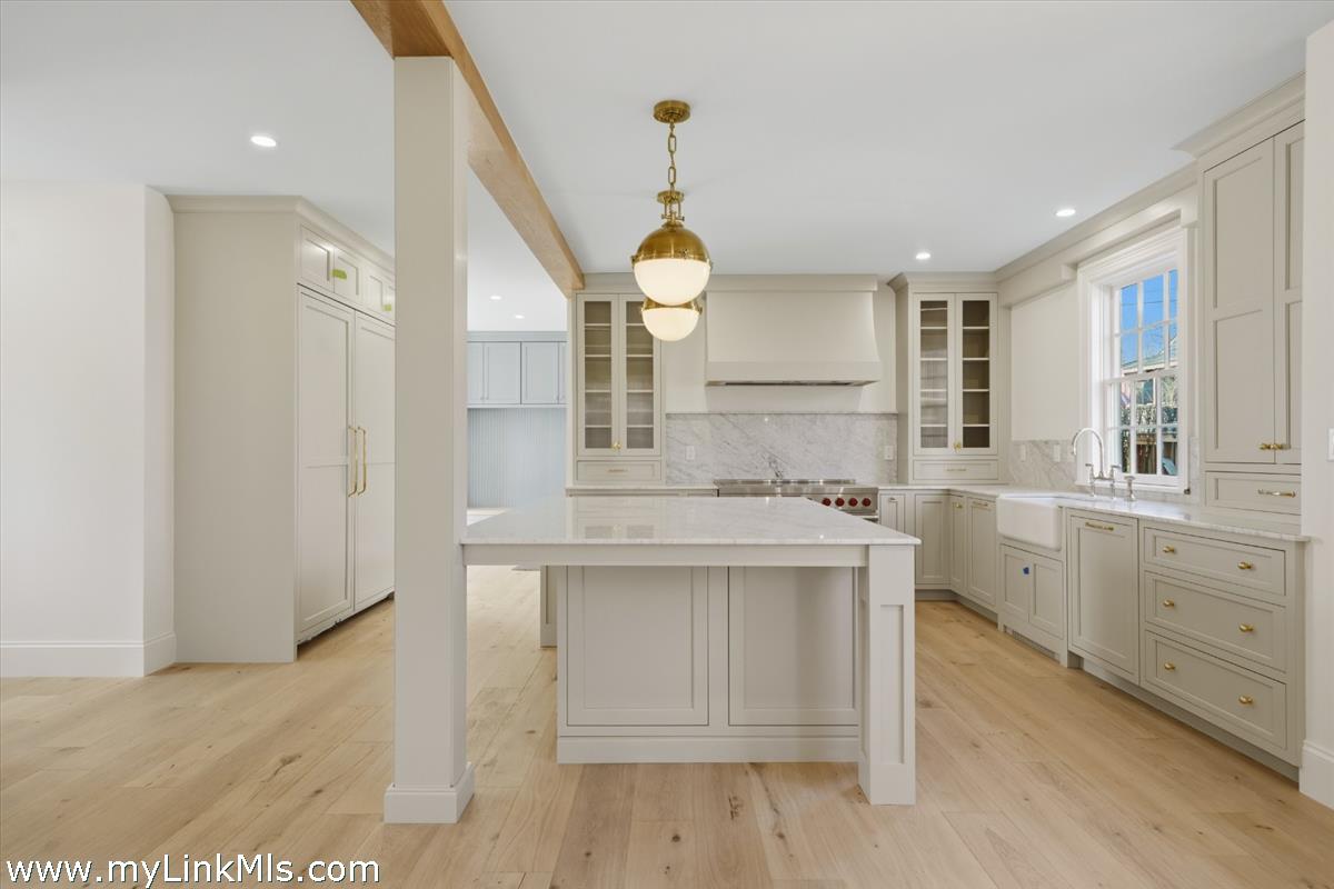 85 Orange Street Nantucket, MA 02554 - Photo 19 of 89 a kitchen with sink cabinets and wooden floor