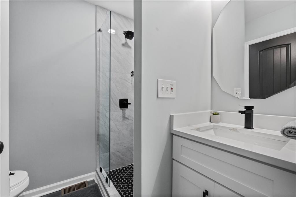 1467 Timms Circle Southeast Atlanta, GA 30316 - Photo 13 of 19 a bathroom with a sink a toilet and shower
