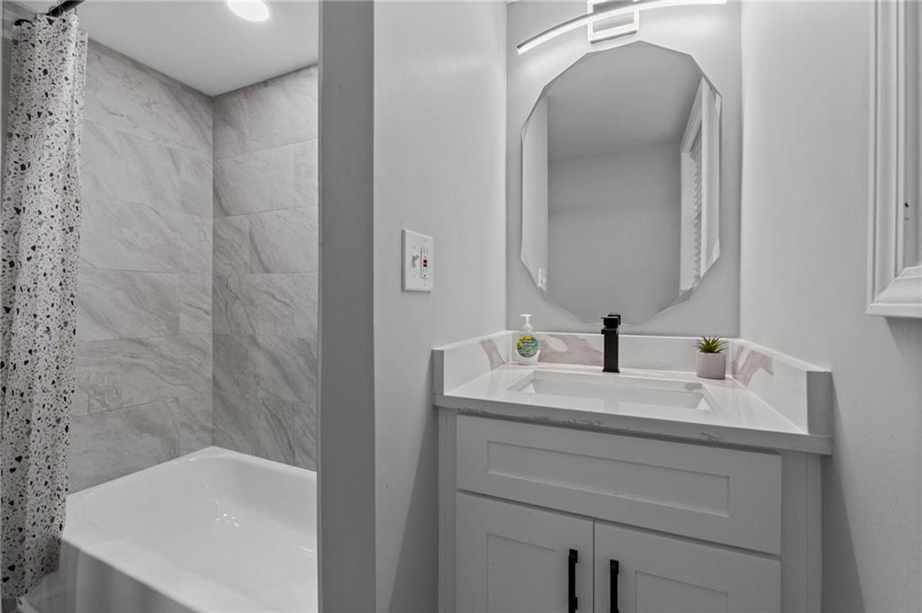 1467 Timms Circle Southeast Atlanta, GA 30316 - Photo 16 of 19 a bathroom with a sink and a bathtub