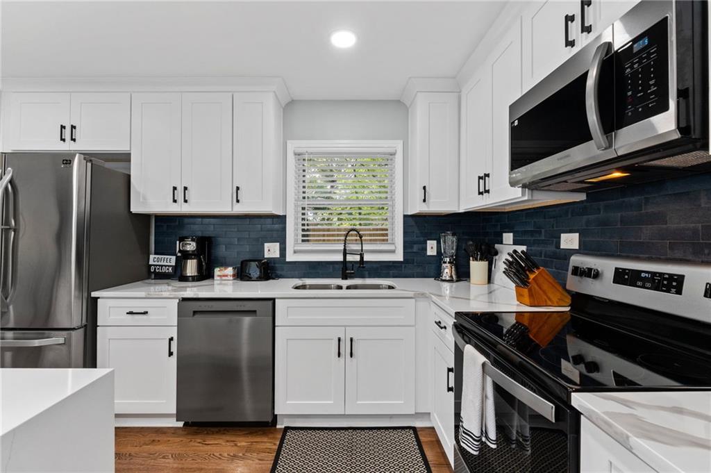 1467 Timms Circle Southeast Atlanta, GA 30316 - Photo 6 of 19 a kitchen with stainless steel appliances granite countertop a stove a sink dishwasher and a refrigerator