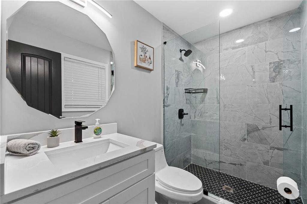 1467 Timms Circle Southeast Atlanta, GA 30316 - Photo 10 of 19 a bathroom with a sink a toilet and shower