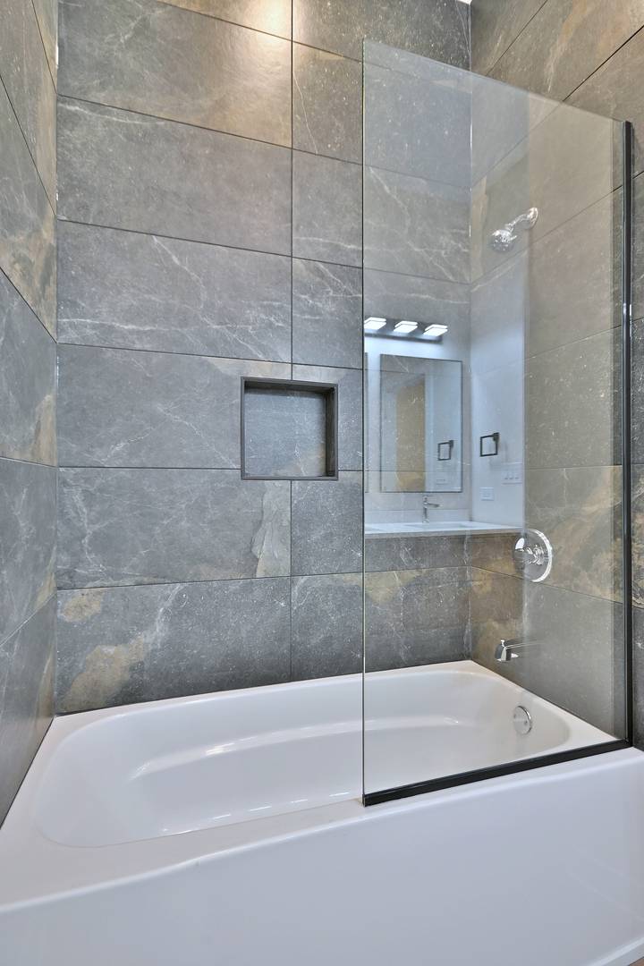 7518 Madison Street, Unit E Forest Park, IL 60130 - Photo 23 of 30 a bathroom with a bathtub and a shower