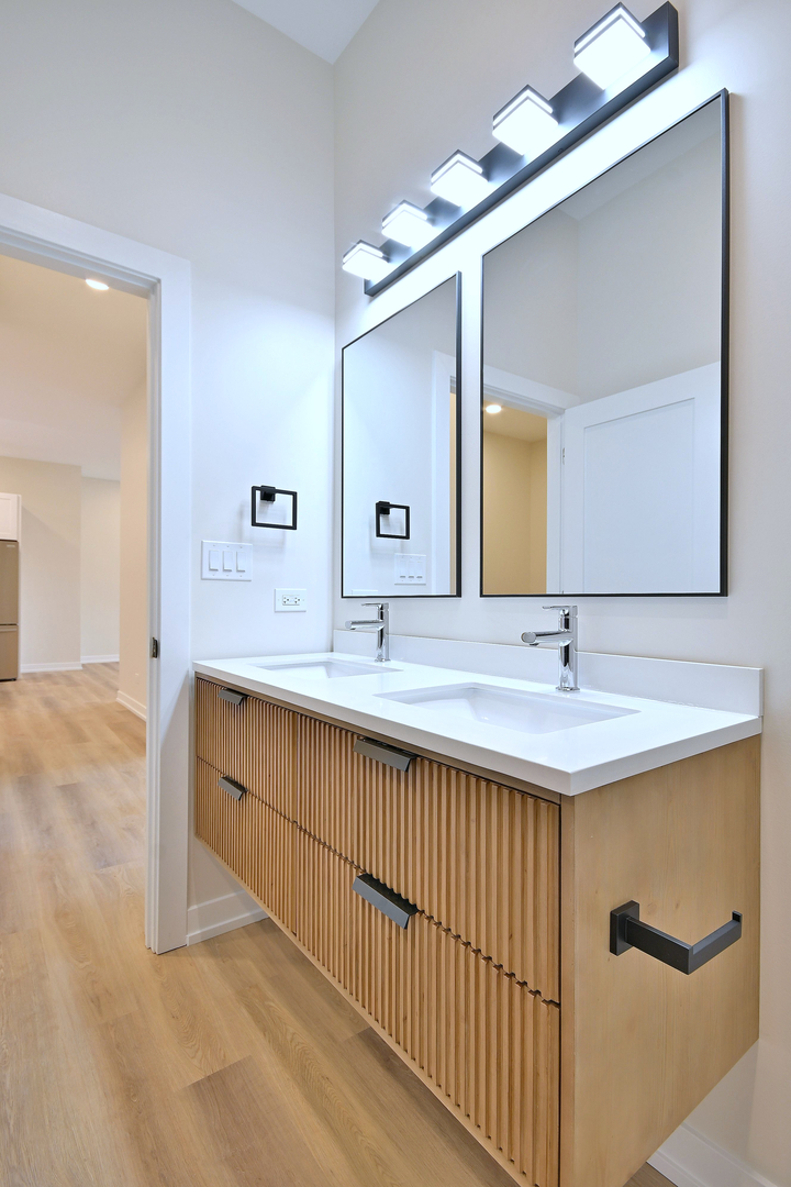 7518 Madison Street, Unit E Forest Park, IL 60130 - Photo 24 of 30 a bathroom with a double vanity sink and a mirror