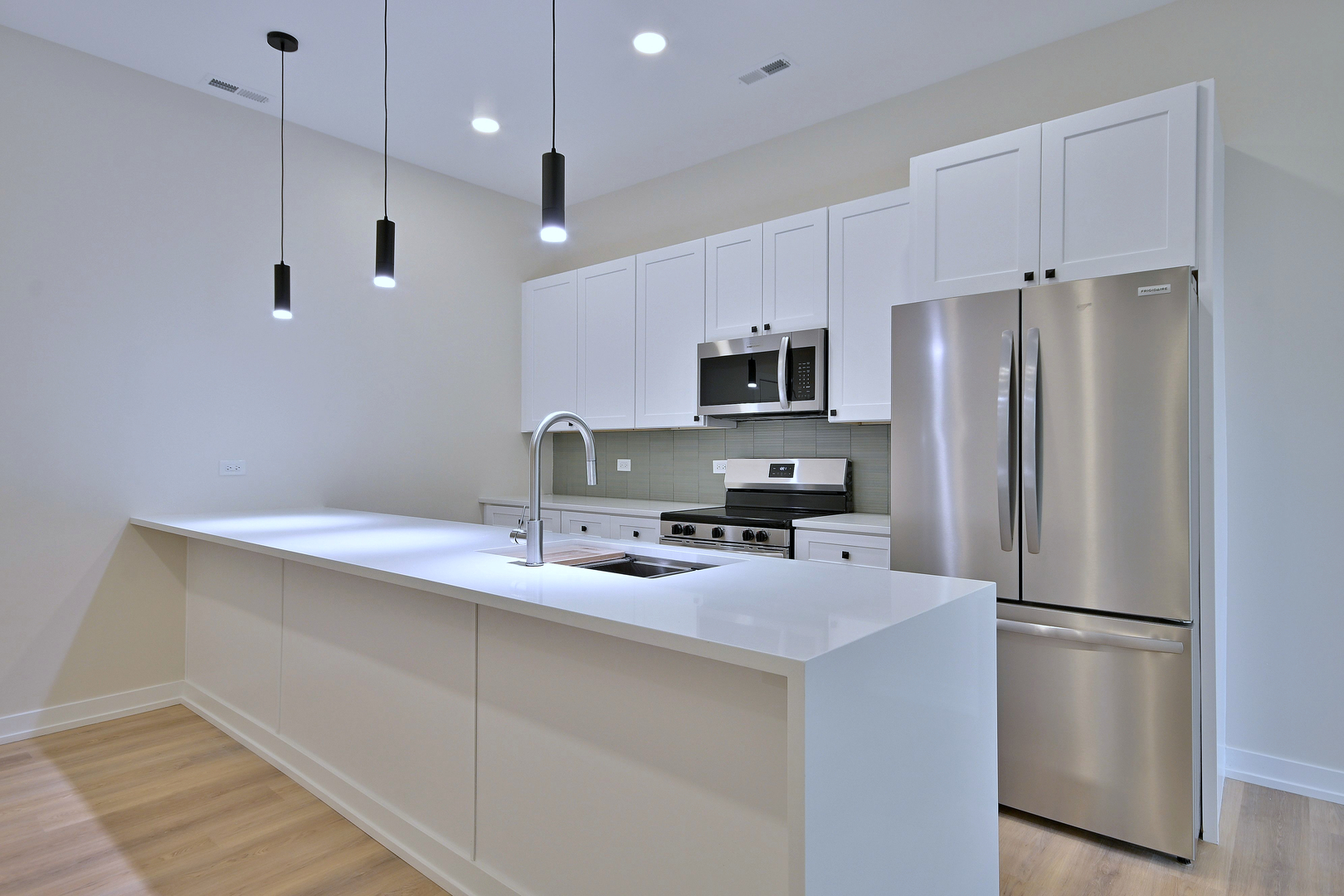 7518 Madison Street, Unit E Forest Park, IL 60130 - Photo 5 of 30 a kitchen with stainless steel appliances a refrigerator sink and microwave