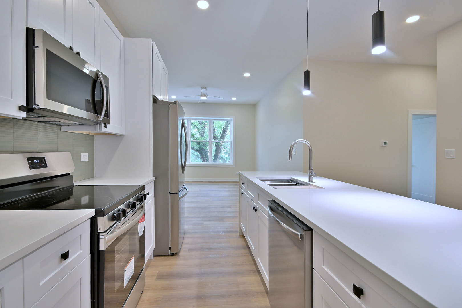 7518 Madison Street, Unit E Forest Park, IL 60130 - Photo 10 of 30 a kitchen with a sink stove and microwave