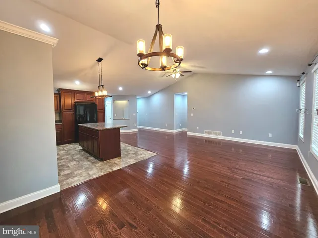 a view of a room with a kitchen and chandelier