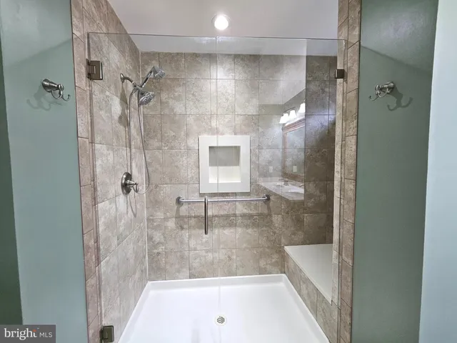 a bathroom with a shower and a bath tub