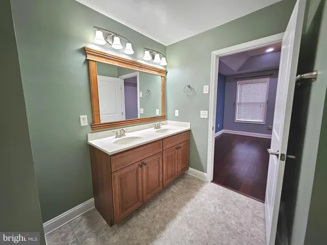 a bathroom with a sink a mirror and a vanity