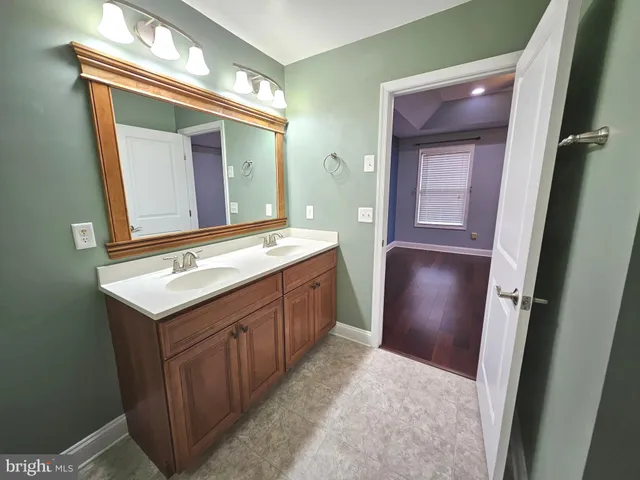 a bathroom with a sink a mirror and a vanity