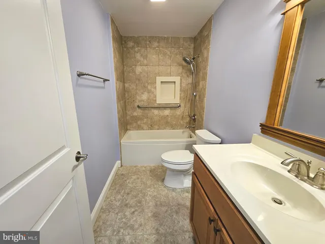 a white toilet sitting next to a bathroom sink