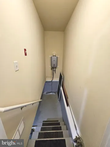 a view of an empty room with kitchen