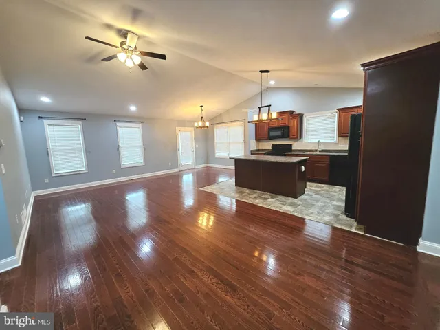 a view of a kitchen with a sink and a refrigerator