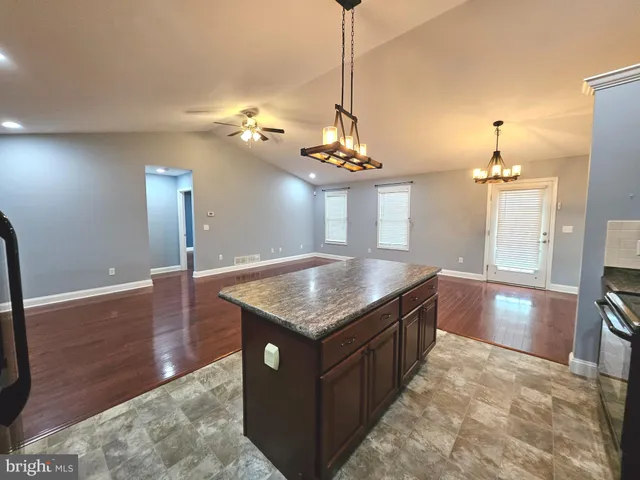 a kitchen with granite countertop cabinets a sink and dishwasher