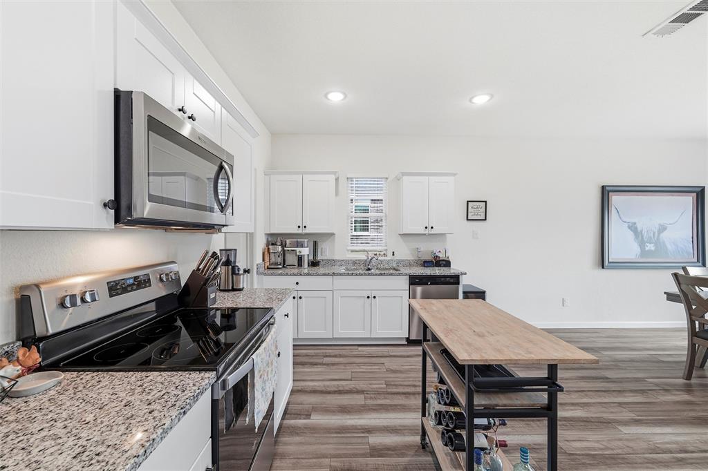 2616 Beech Crk Road Glenn Heights, TX 75154 - Photo 14 of 40 a kitchen with a stove a sink and a microwave