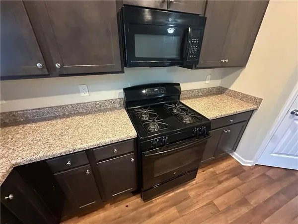 a kitchen with wooden cabinets and a stove top oven