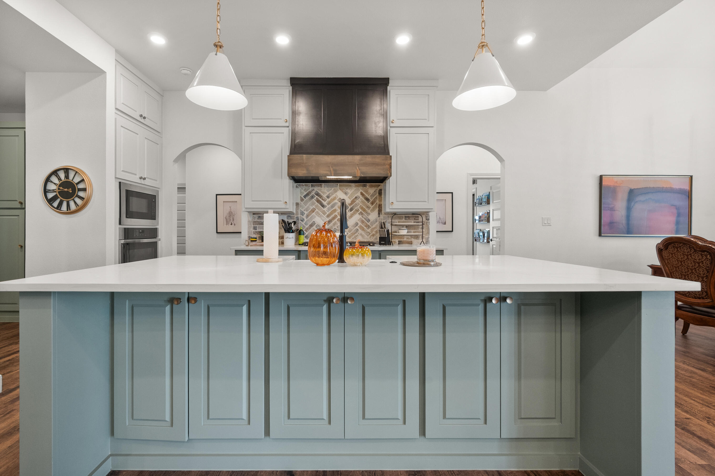 4509 140th Street Lubbock, TX 79424 - Photo 11 of 41 a kitchen with a sink a clock and cabinets