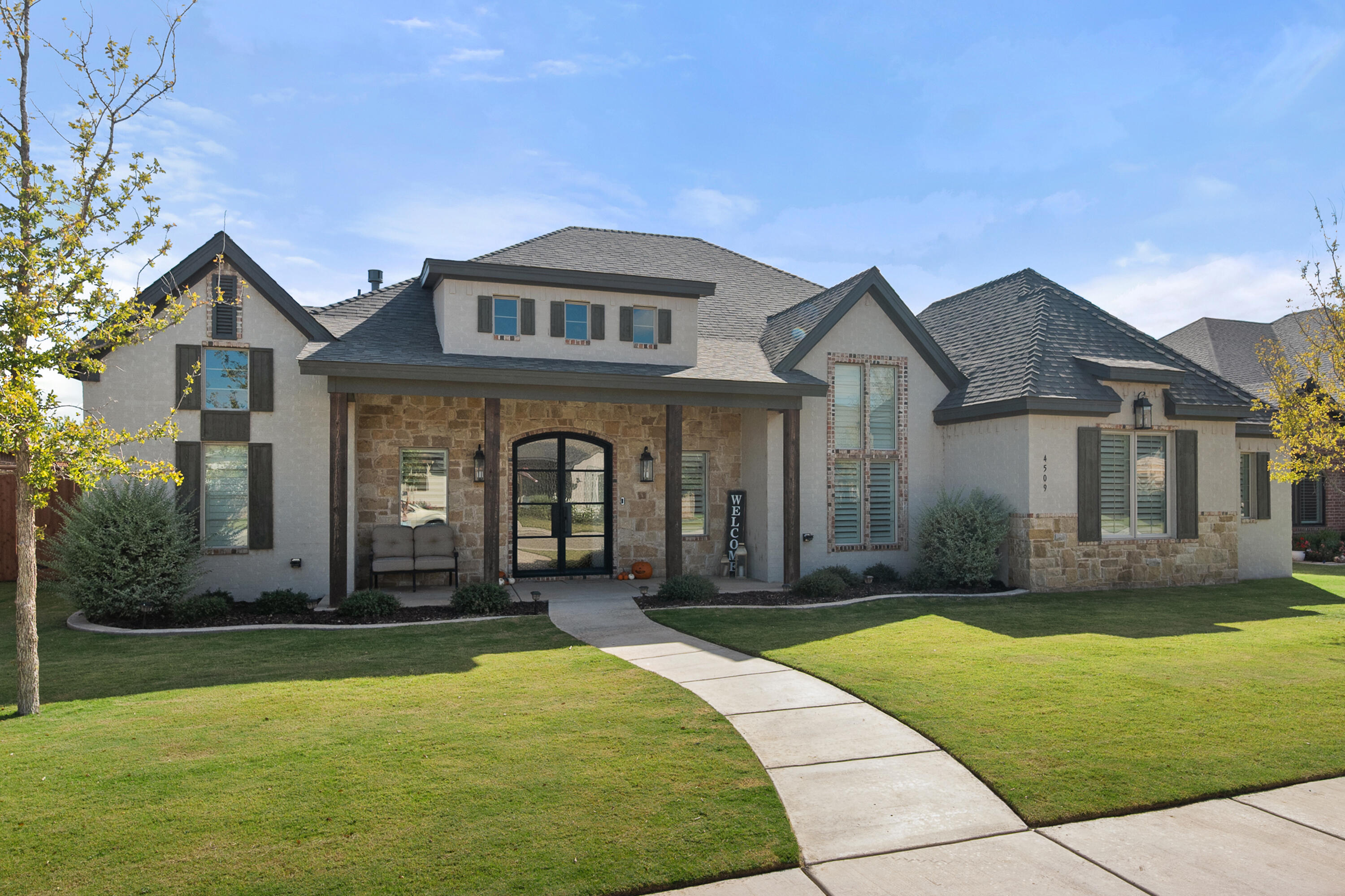 4509 140th Street Lubbock, TX 79424 - Photo 2 of 41 a front view of a house with a yard