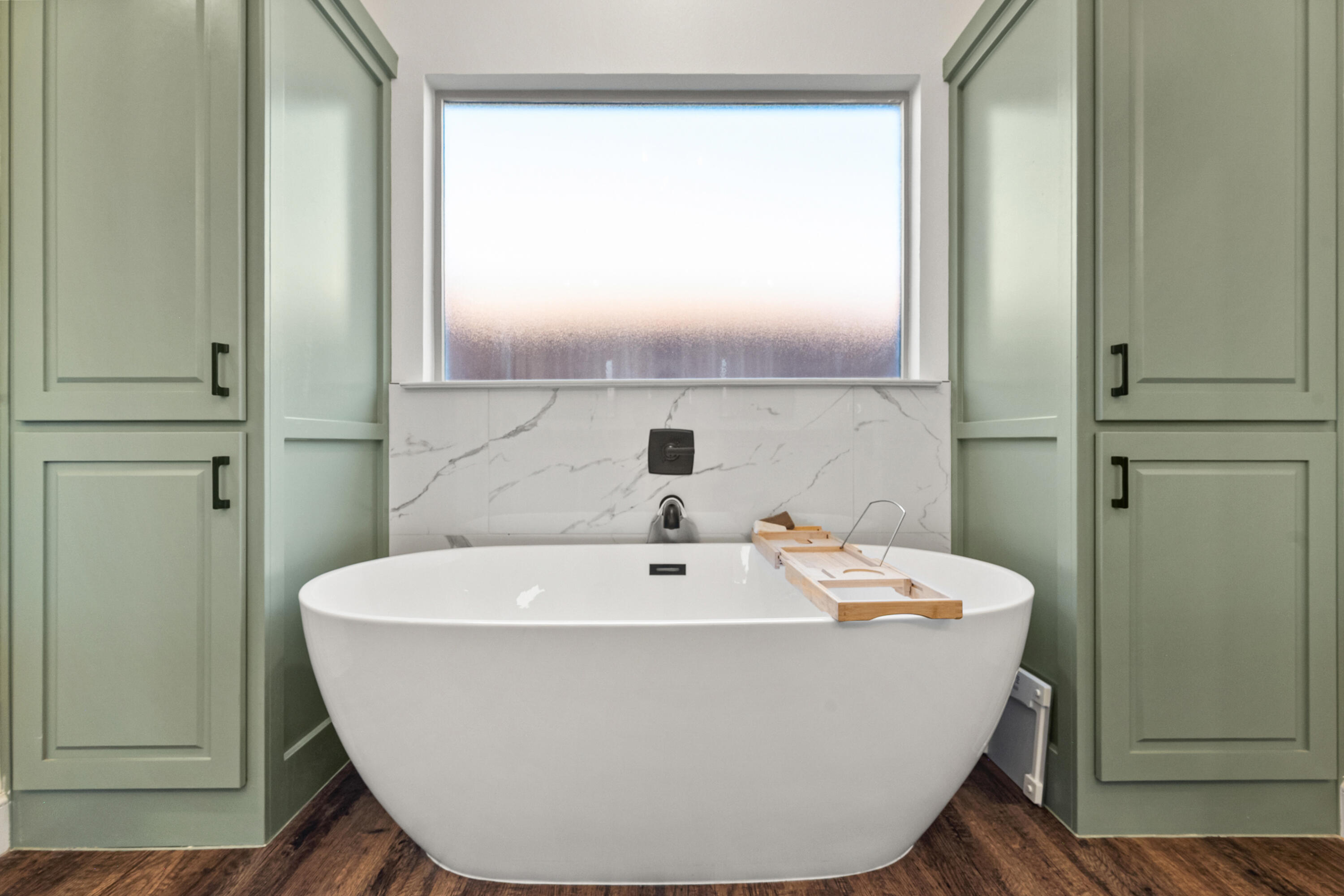 4509 140th Street Lubbock, TX 79424 - Photo 28 of 41 a white bath tub sitting in a bathroom