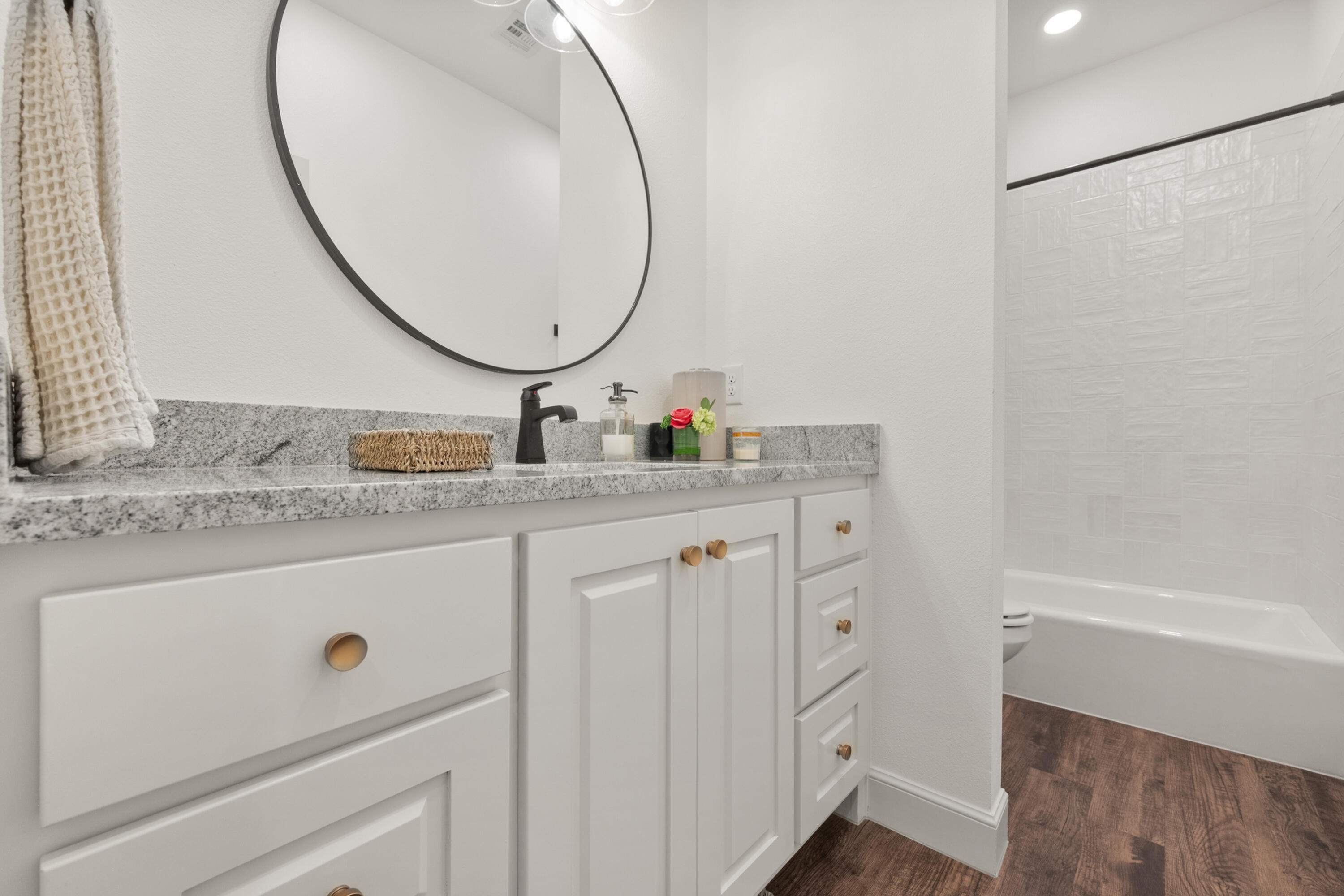 4509 140th Street Lubbock, TX 79424 - Photo 34 of 41 a bathroom with a sink mirror vanity and a shower