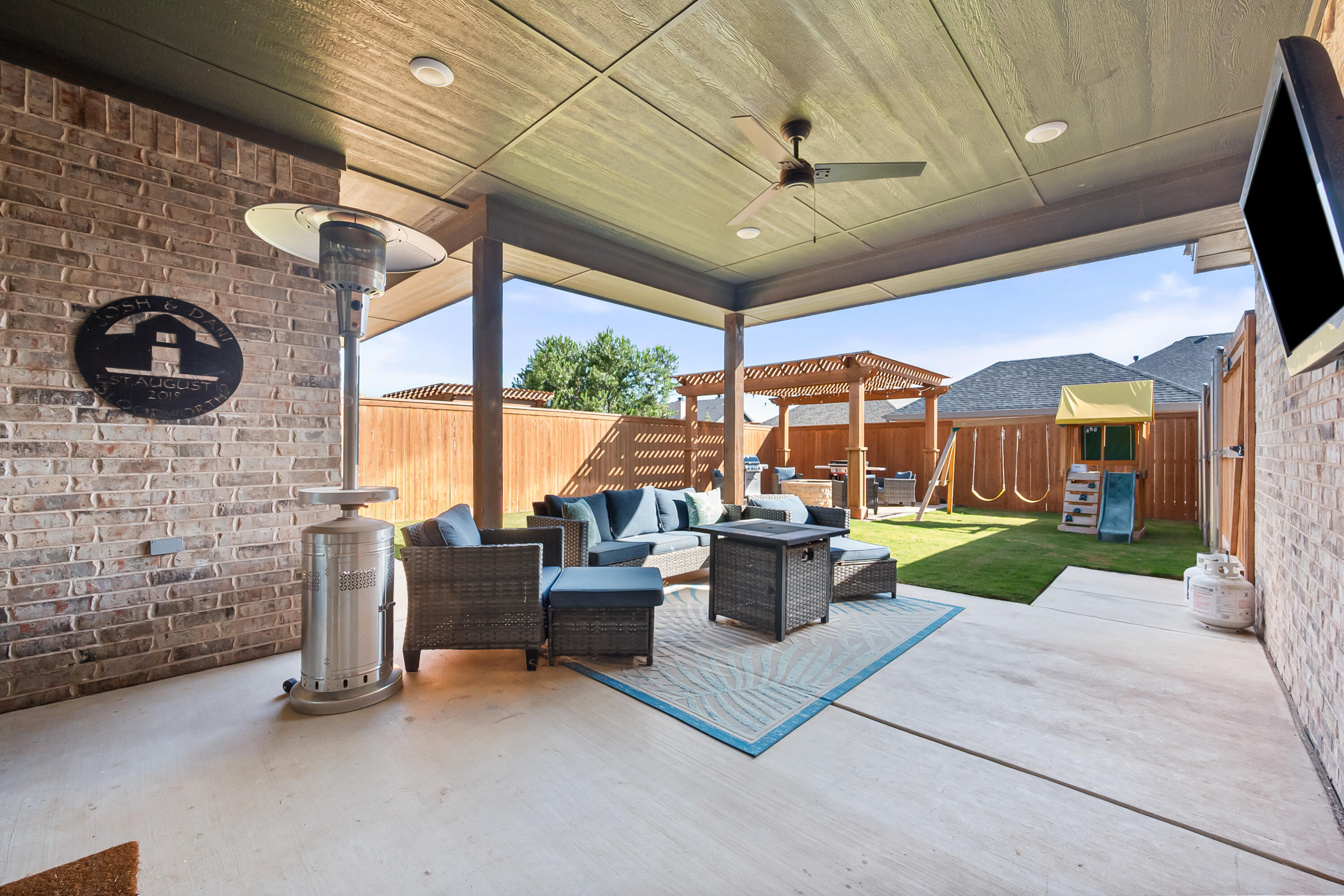 4509 140th Street Lubbock, TX 79424 - Photo 39 of 41 a view of a patio with couches chairs potted plants and a table and chairs